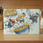 "Whisk Takers" cartoon cutting board featuring superheroes with egg heads and a whisk.