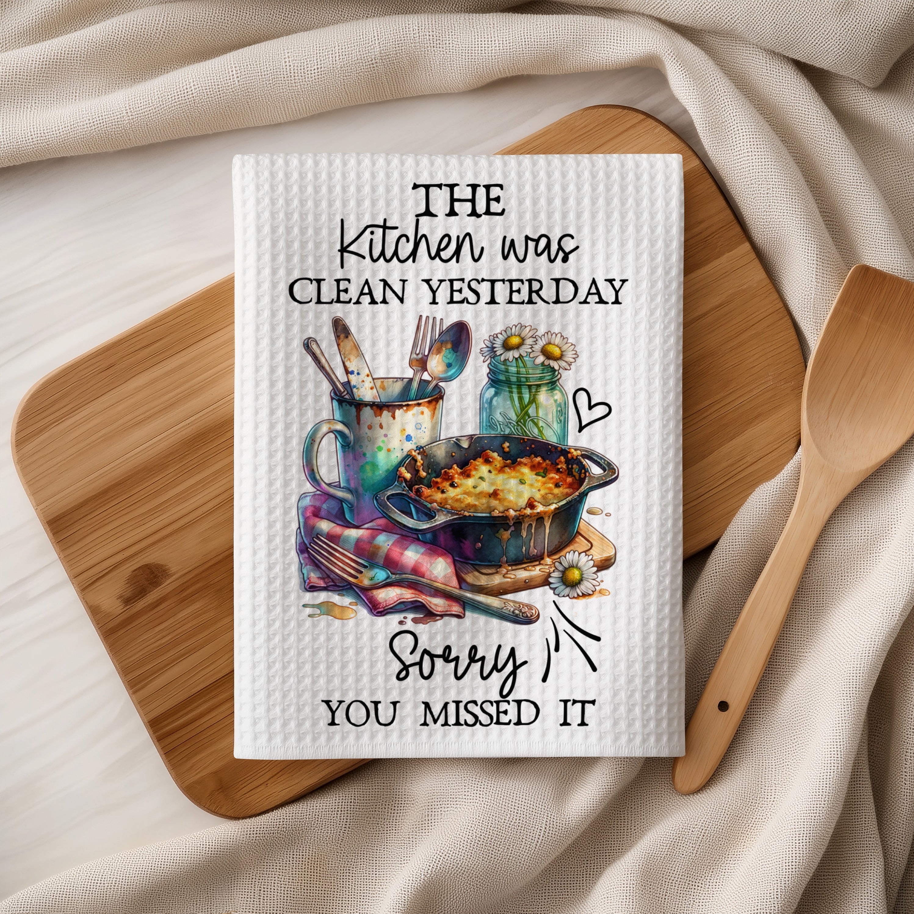 Kitchen towel with text "The kitchen was clean yesterday. Sorry you missed it."