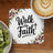 "Walk by Faith" quote on a coaster with floral accents, next to coffee and kiwi.