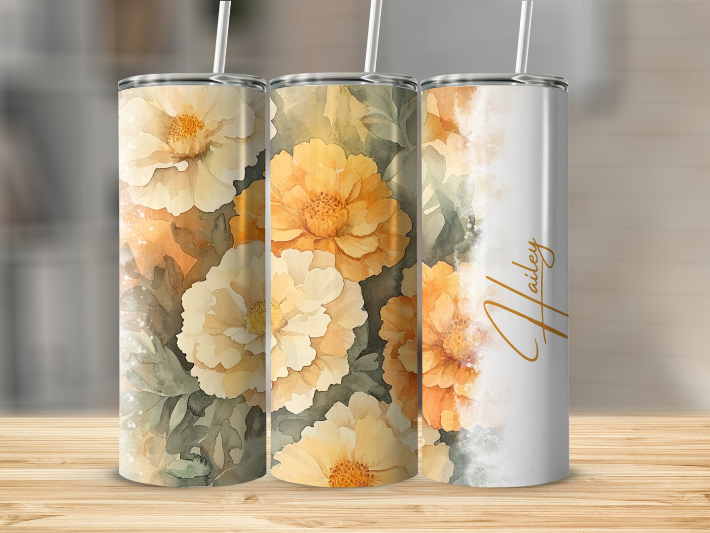Three tumblers with yellow floral designs, one personalized with "Hailey".