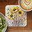 Yellow anemone flowers with watercolor accents and text "live a great story".
