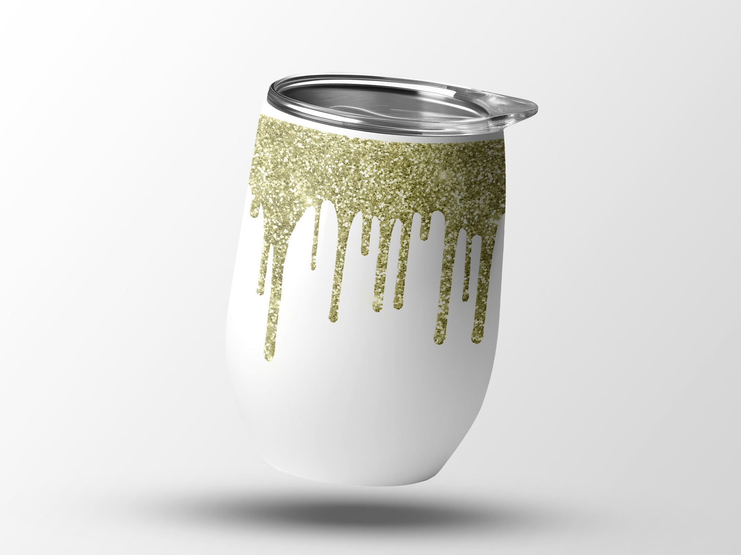 White tumbler with gold glitter drips and a silver lid.