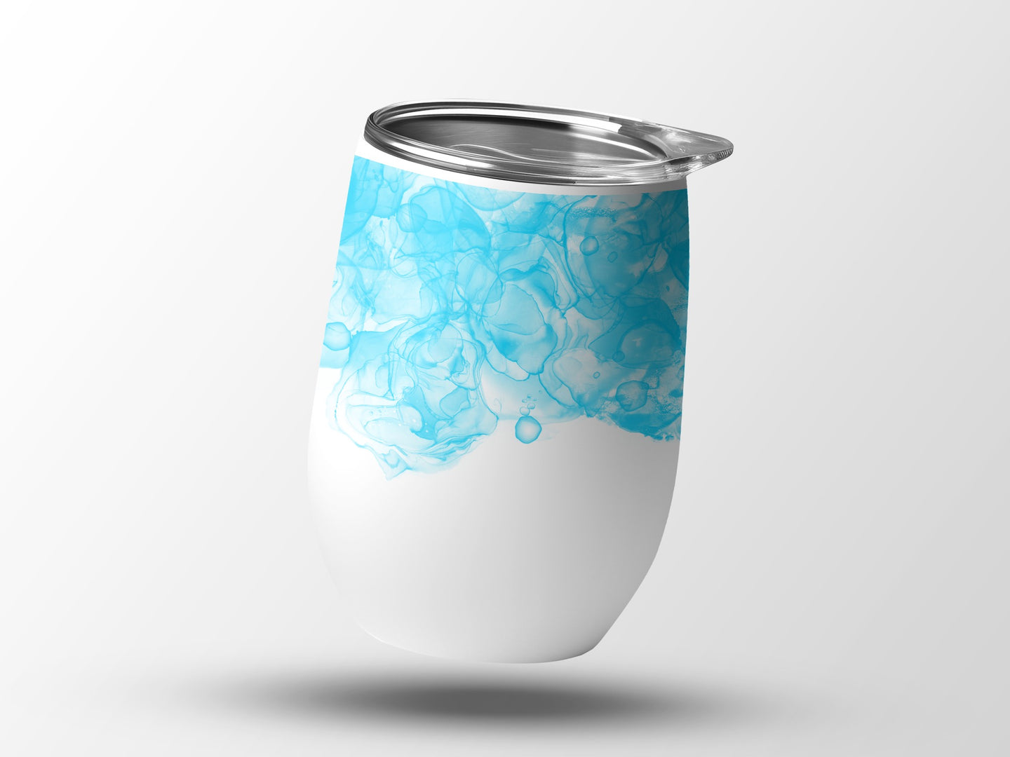 White tumbler with blue watercolor abstract design and silver lid.