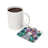 Coaster with tattooed woman and sunflowers, "Dream Big" text, next to coffee mug.
