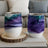 Two abstract art stemless wine glasses with purple, green, and blue swirling designs.