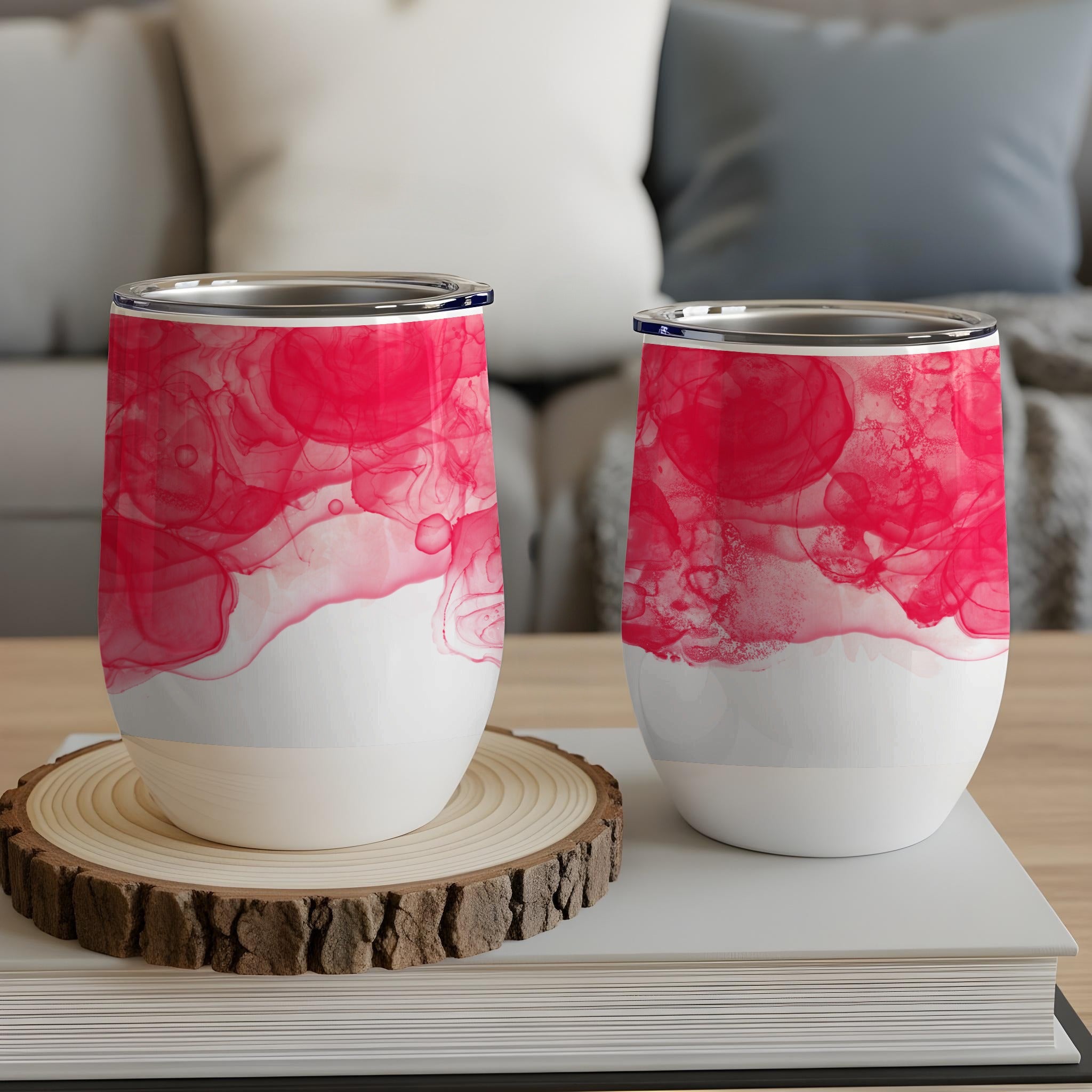 Two white tumblers with pink watercolor patterns.