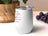 White tumbler with "Might be coffee, might be wine" text and colorful splashes.