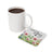 White mug with coffee next to a floral coaster with text REMEMBER YOUR why.