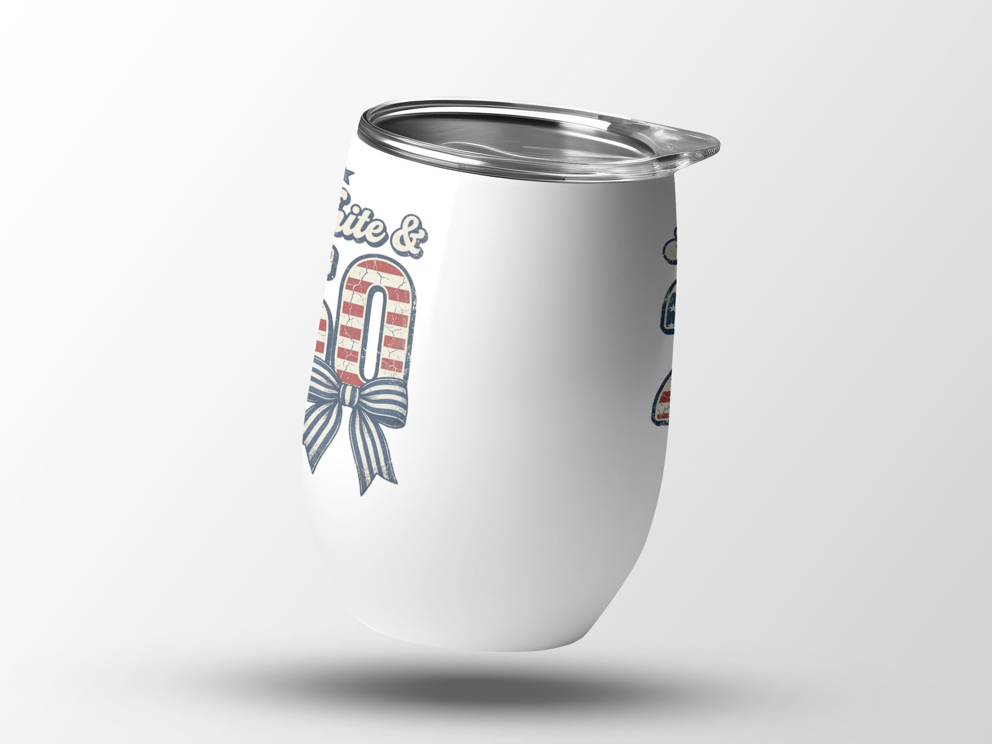 White tumbler with red, white, and blue patriotic design and bow.