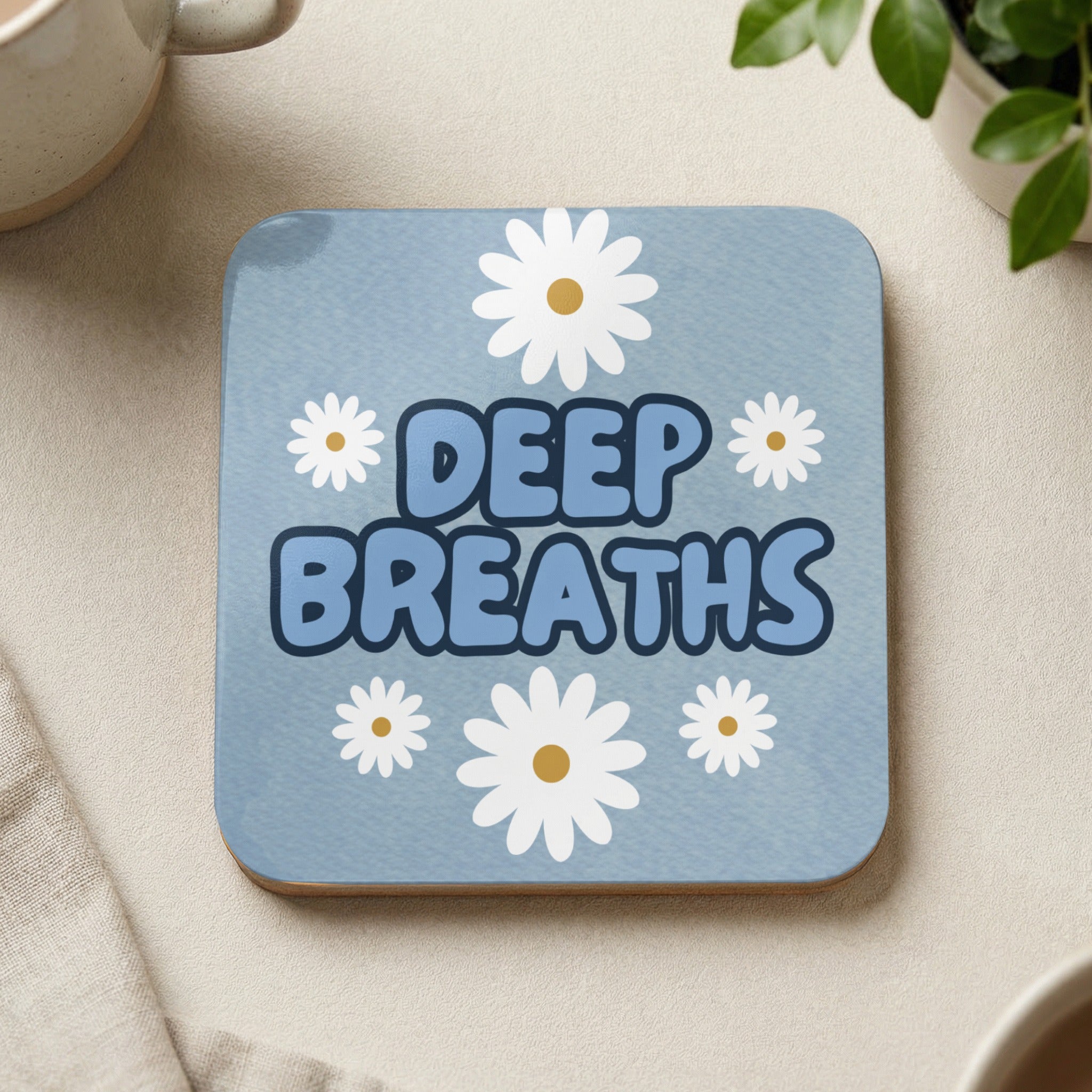 Blue coaster with white daisies and "DEEP BREATHS" text.