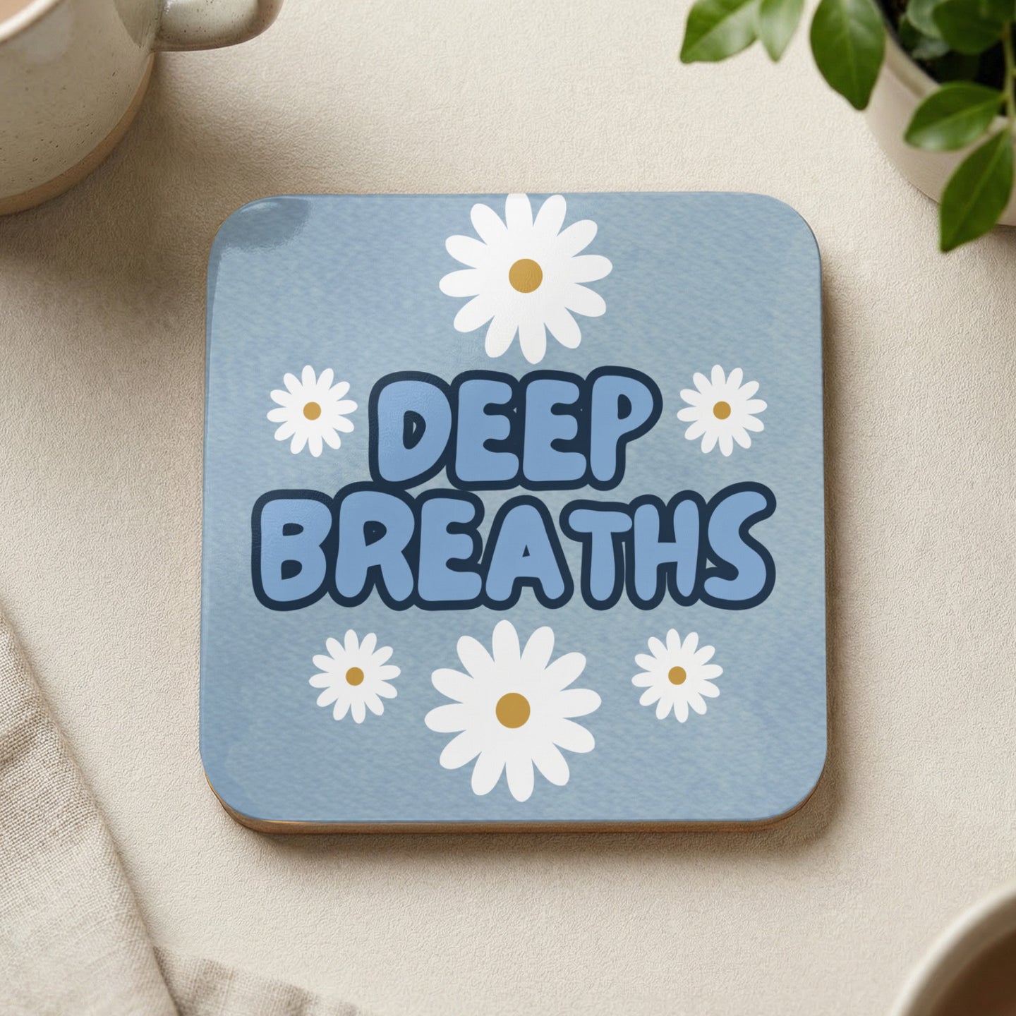 Blue coaster with white daisies and "DEEP BREATHS" text.