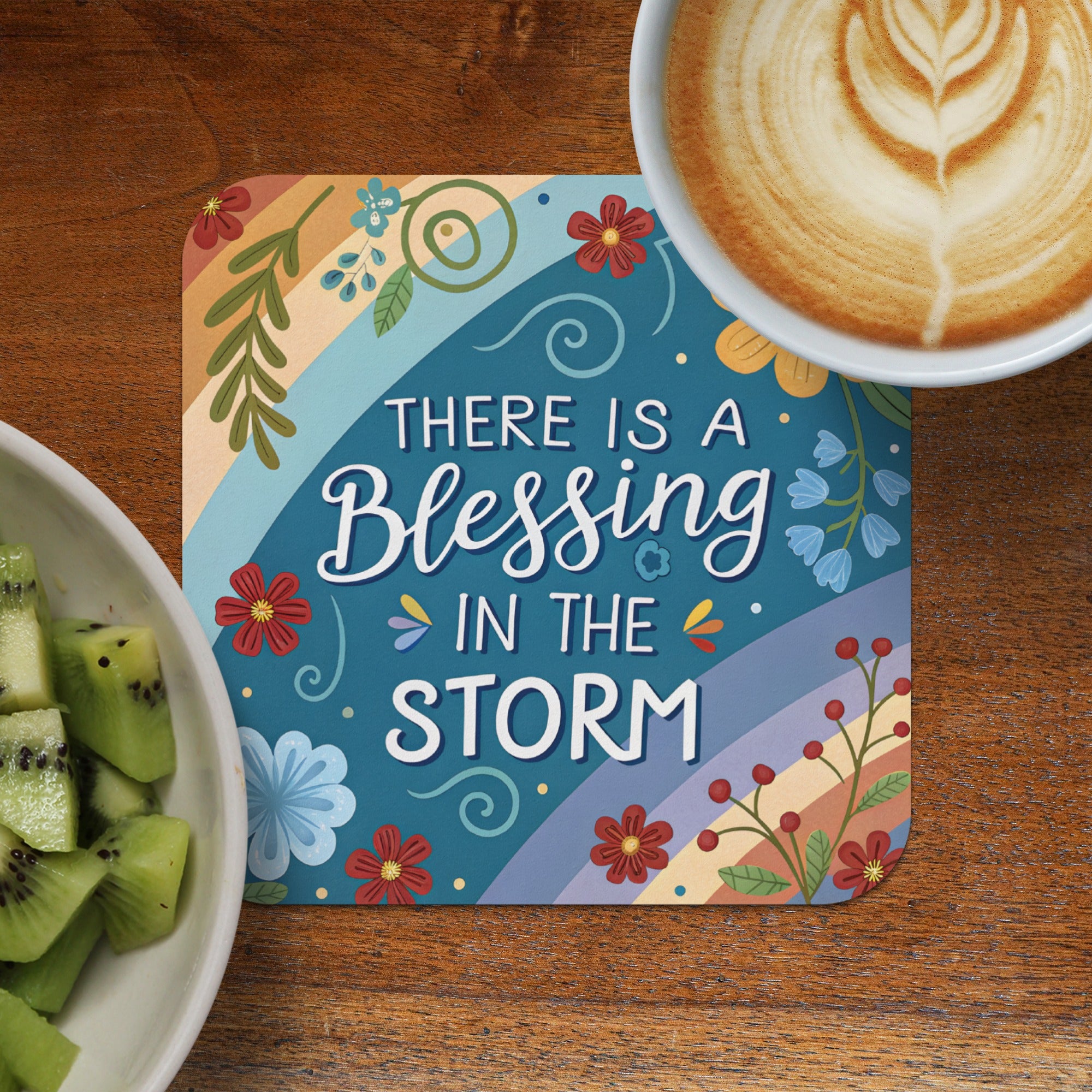Coaster with "There is a blessing in the storm" text and floral design.