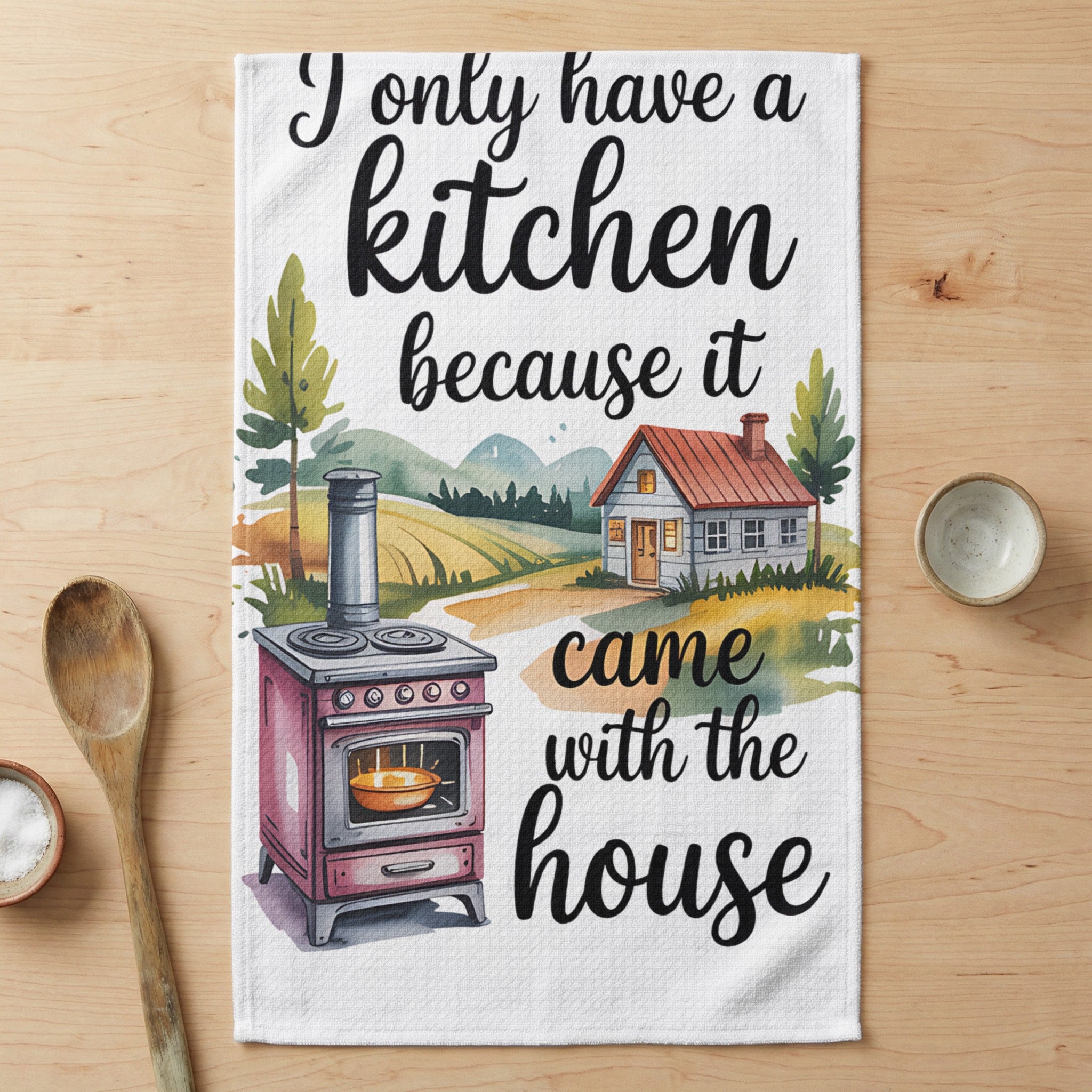 Towel with watercolor illustration of a kitchen scene and text.