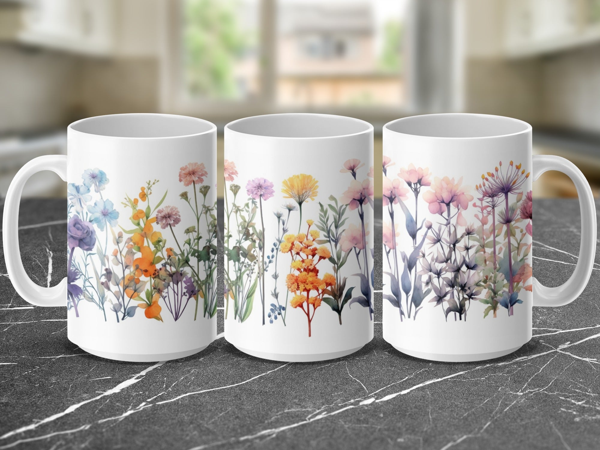 Three white mugs displaying colorful floral watercolor designs against a marbled countertop.