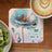 Blue poppy floral coaster with "Be Real Not Perfect" text and a ladybug.