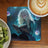 Young woman with flowing blonde hair reading a glowing book, surrounded by magic orbs.