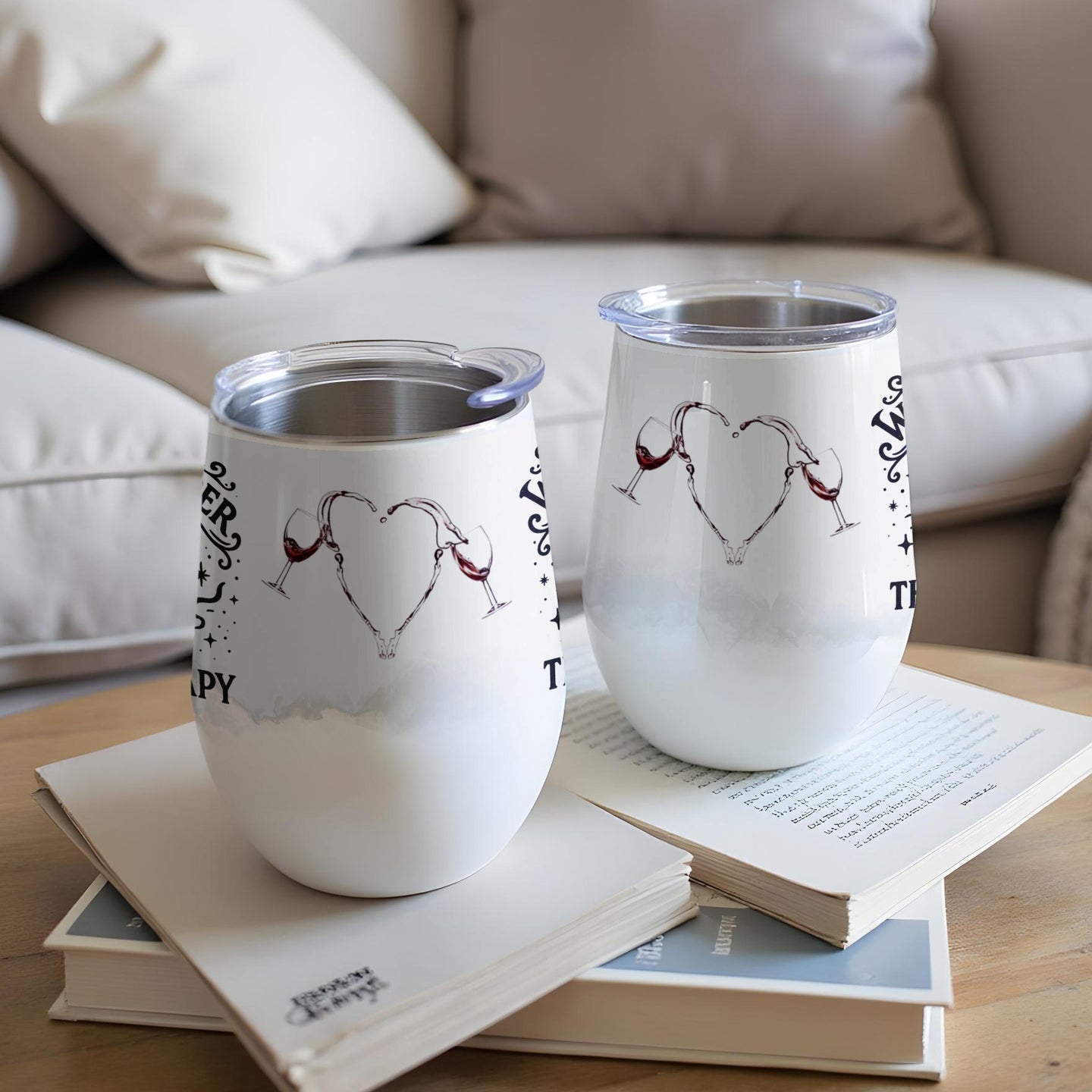 Two white insulated tumblers with wine glass heart design and text.