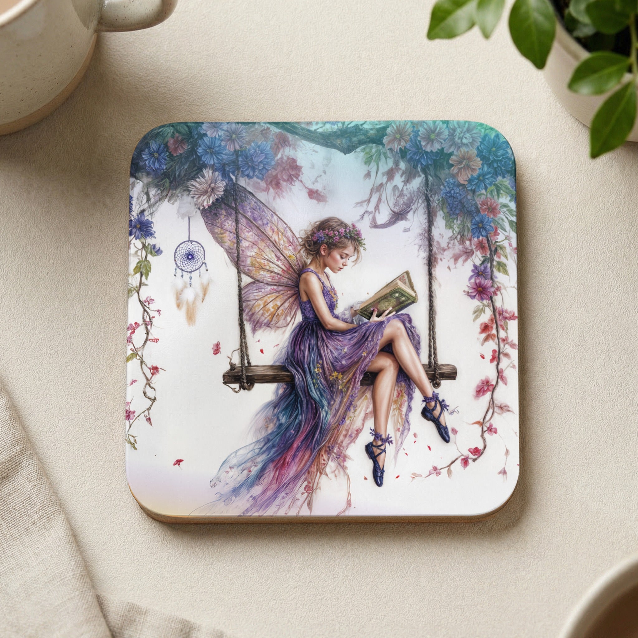 Fairy on a swing reading a book, decorated with flowers and a dreamcatcher.
