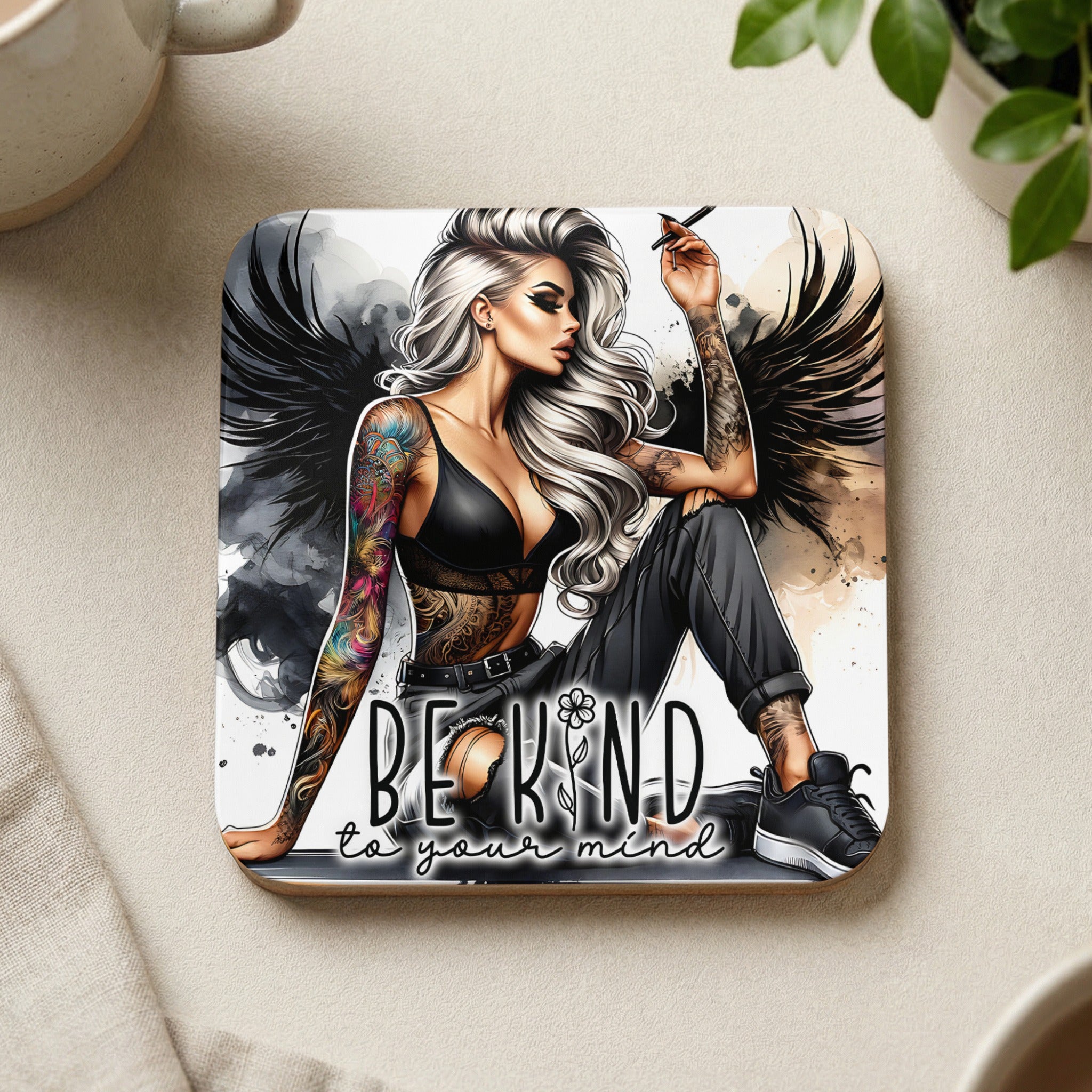 Woman with tattoos and wings, text reads "BE KIND to your mind."