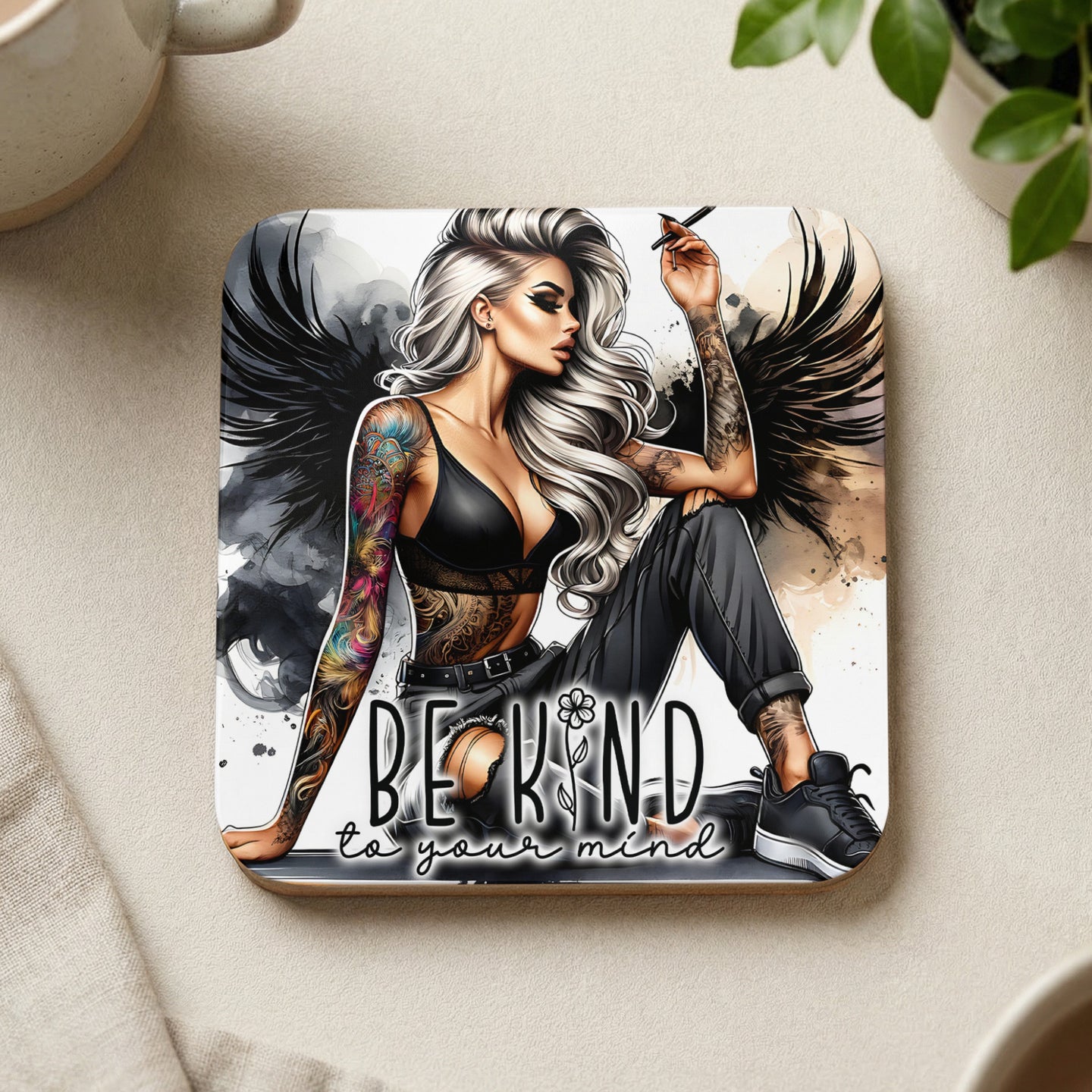 Woman with tattoos and wings, text reads "BE KIND to your mind."