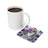 Coaster with tattooed woman and butterflies beside coffee mug.