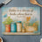 Cutting board with "Better is a dinner of herbs where love is" and butterfly, herbs, flowers.