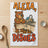 Bear wearing apron and saying "ALEXA, DO THE DISHES" near a sink.
