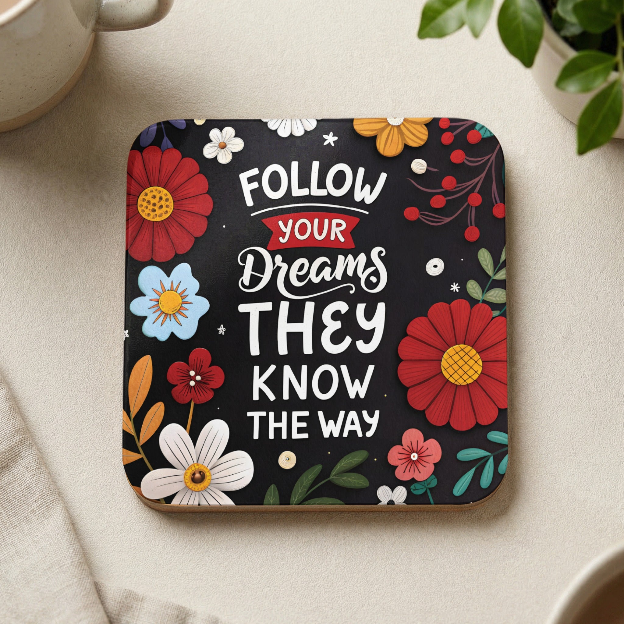 Coaster with "Follow Your Dreams" text and floral accents.