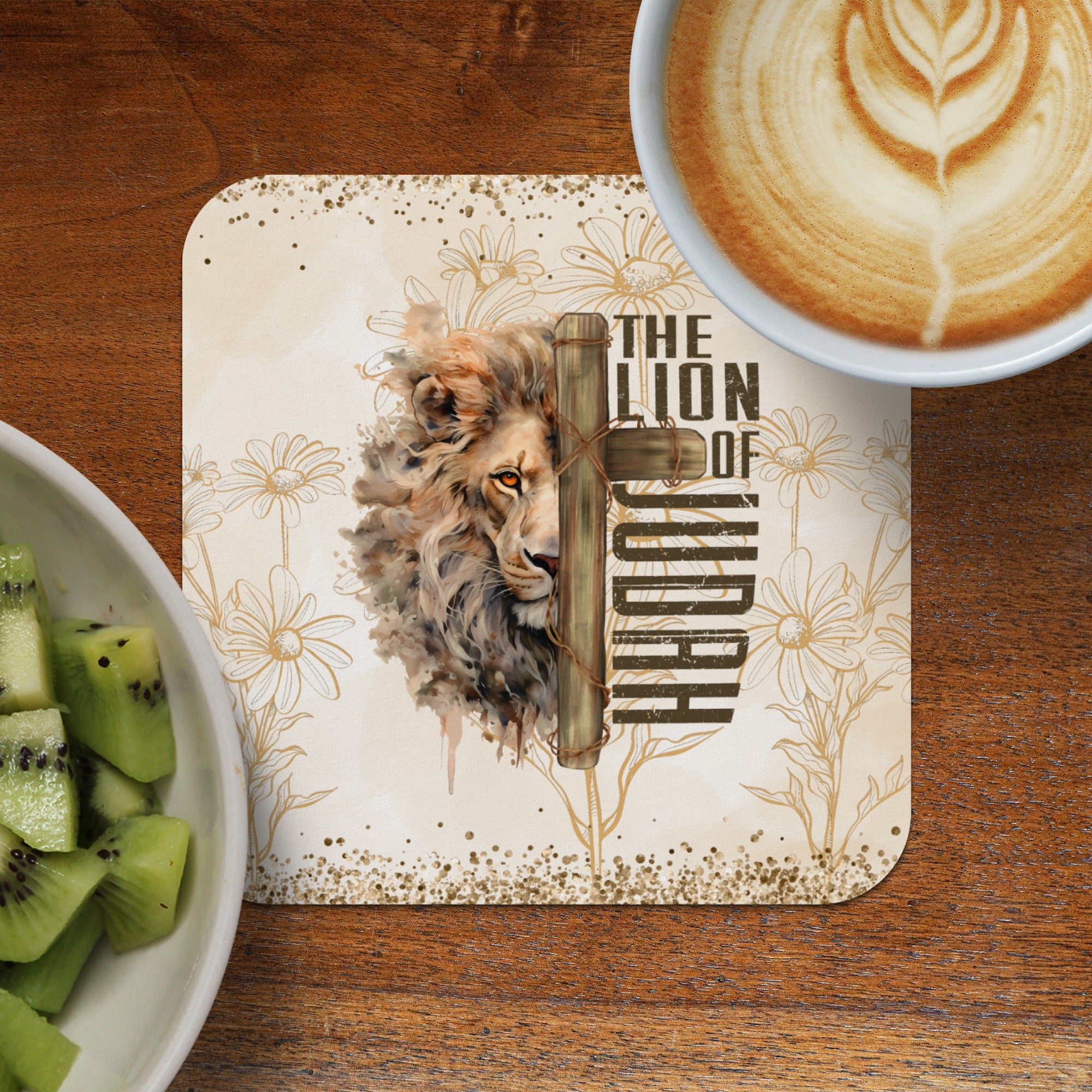 Lion of Judah cross design coaster with coffee and kiwi.