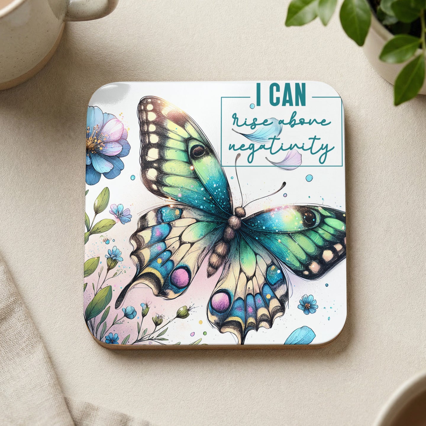 Butterfly with text "I CAN rise above negativity" on a square coaster.