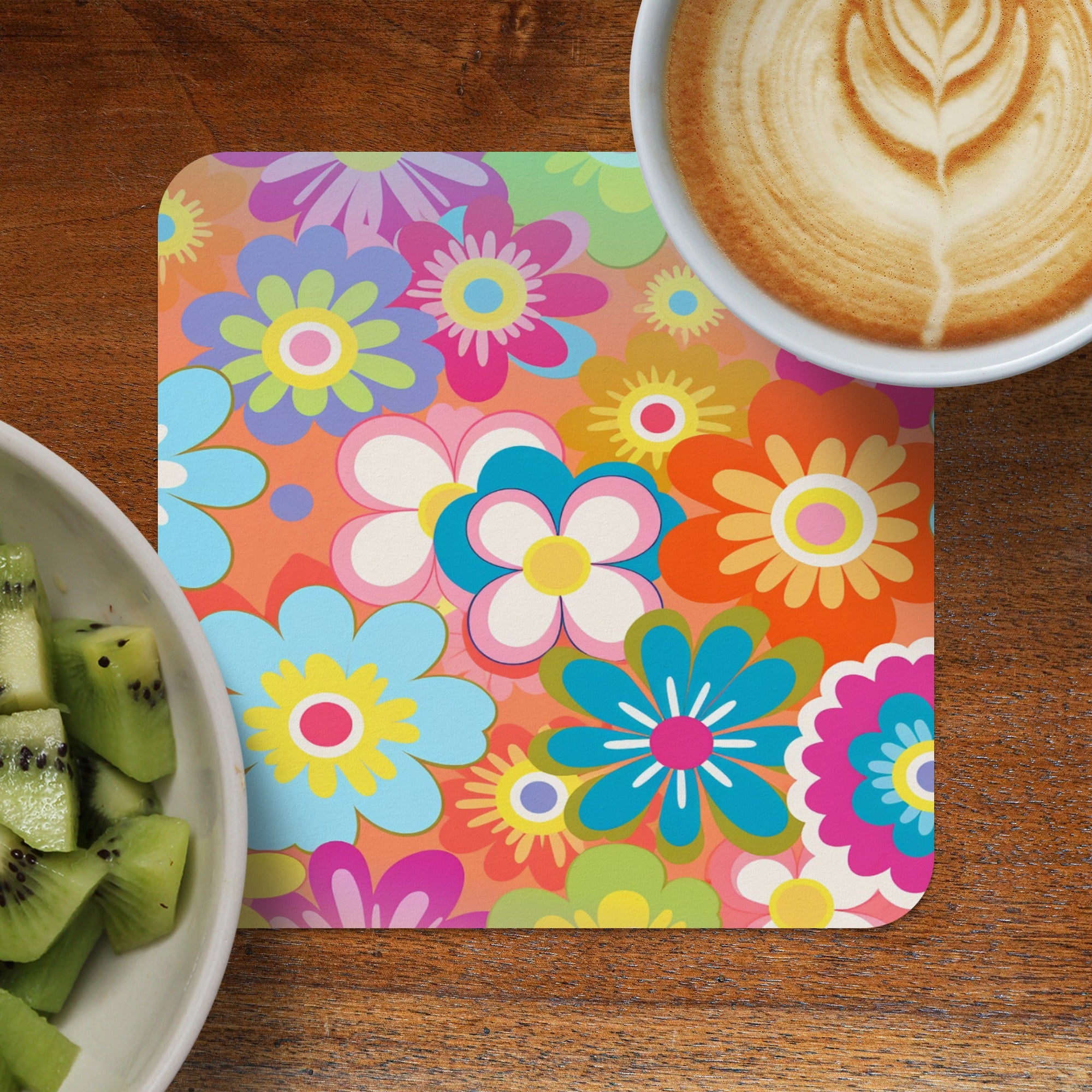 Colorful floral patterned coaster with coffee and kiwi.