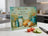 Cutting board with "Give us this day our daily bread" and bread, jar, tomatoes, cucumber.