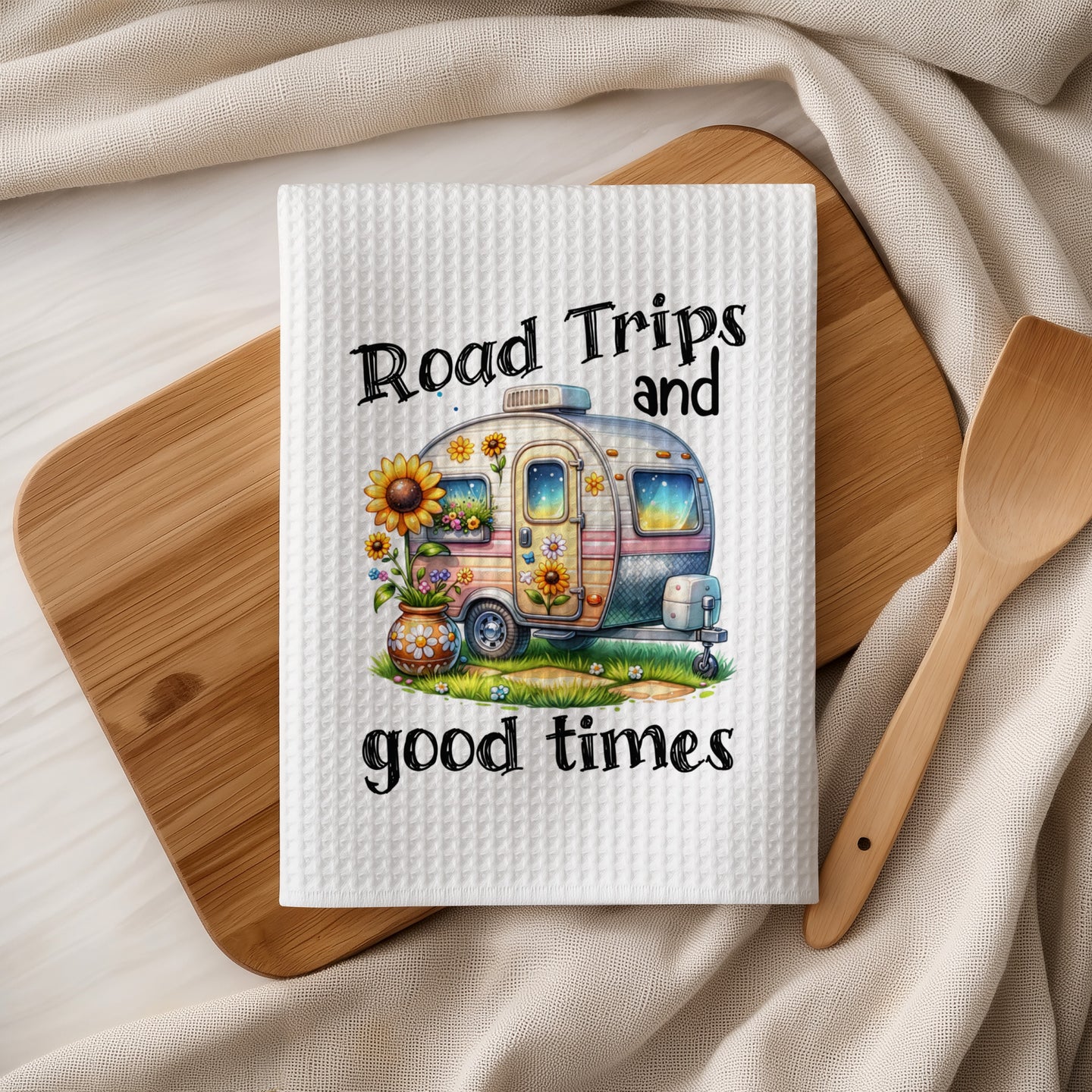 White waffle towel with "Road Trips and good times" and camper illustration.