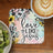 Coaster with "Love like Jesus" text and floral design, beside kiwi and coffee.