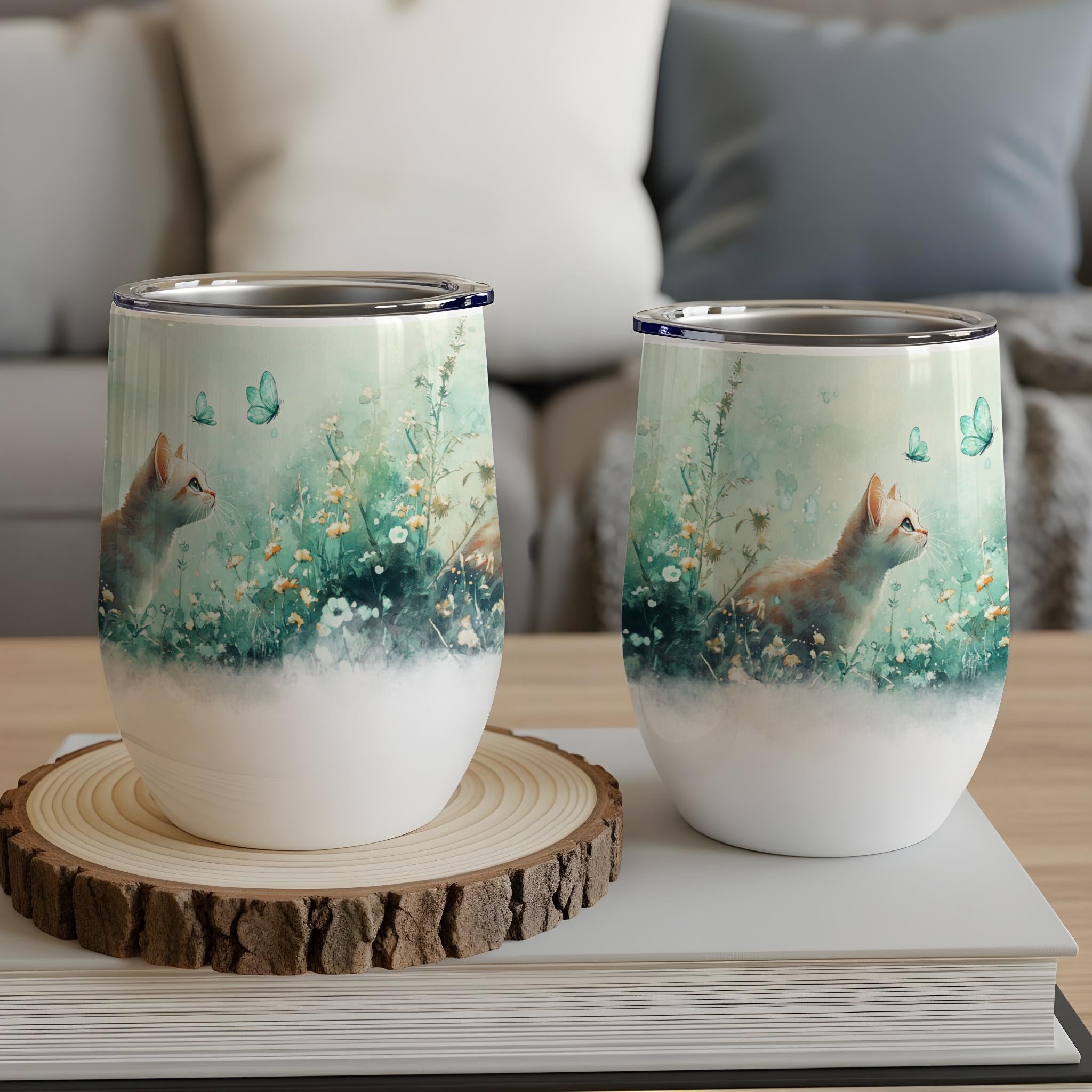 Two wine tumblers with a cat and floral watercolor design.