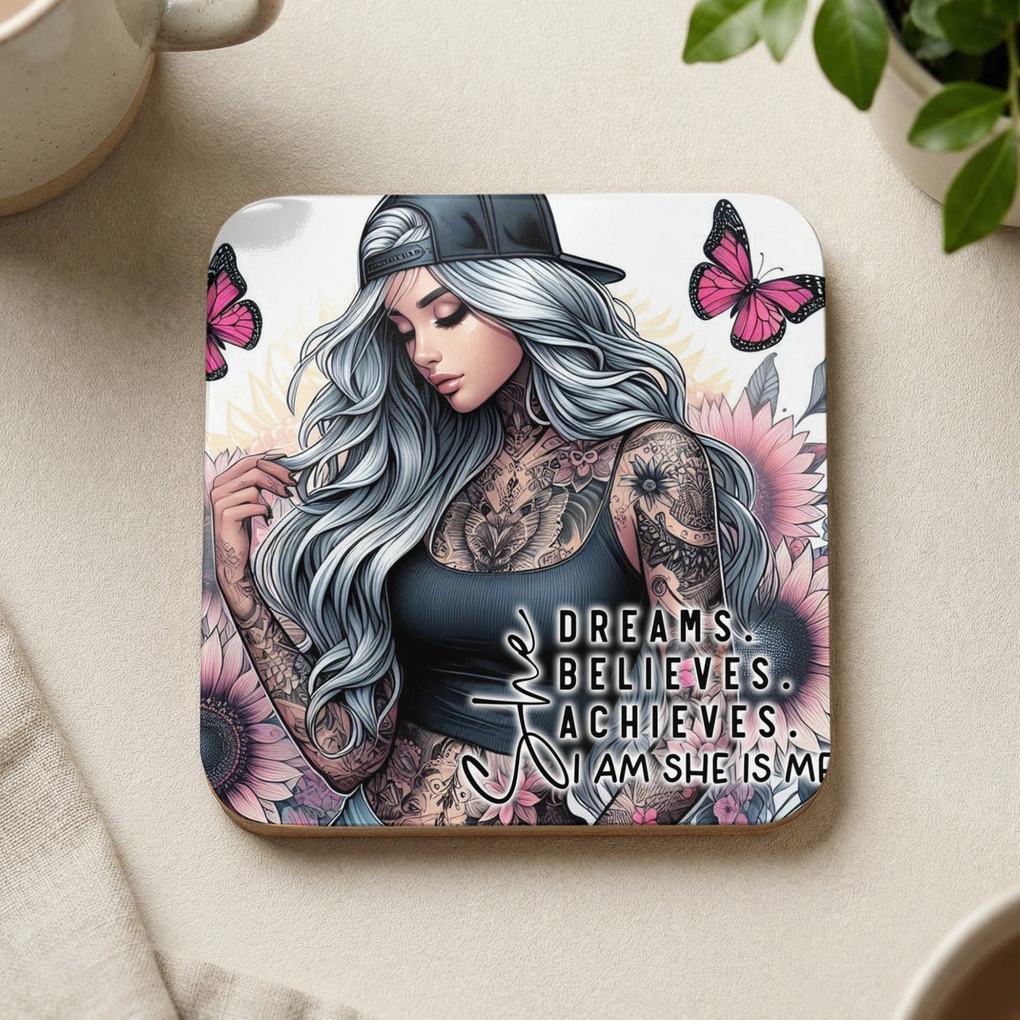Coaster with tattooed woman, butterflies, and inspirational text "Dreams. Believe. Achieves. I Am She Is Me."