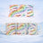 Mug with colorful handwritten positive affirmations on a snowy background.
