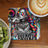 Woman with rainbow hair, sunglasses, and "you are brave" text on a coaster.