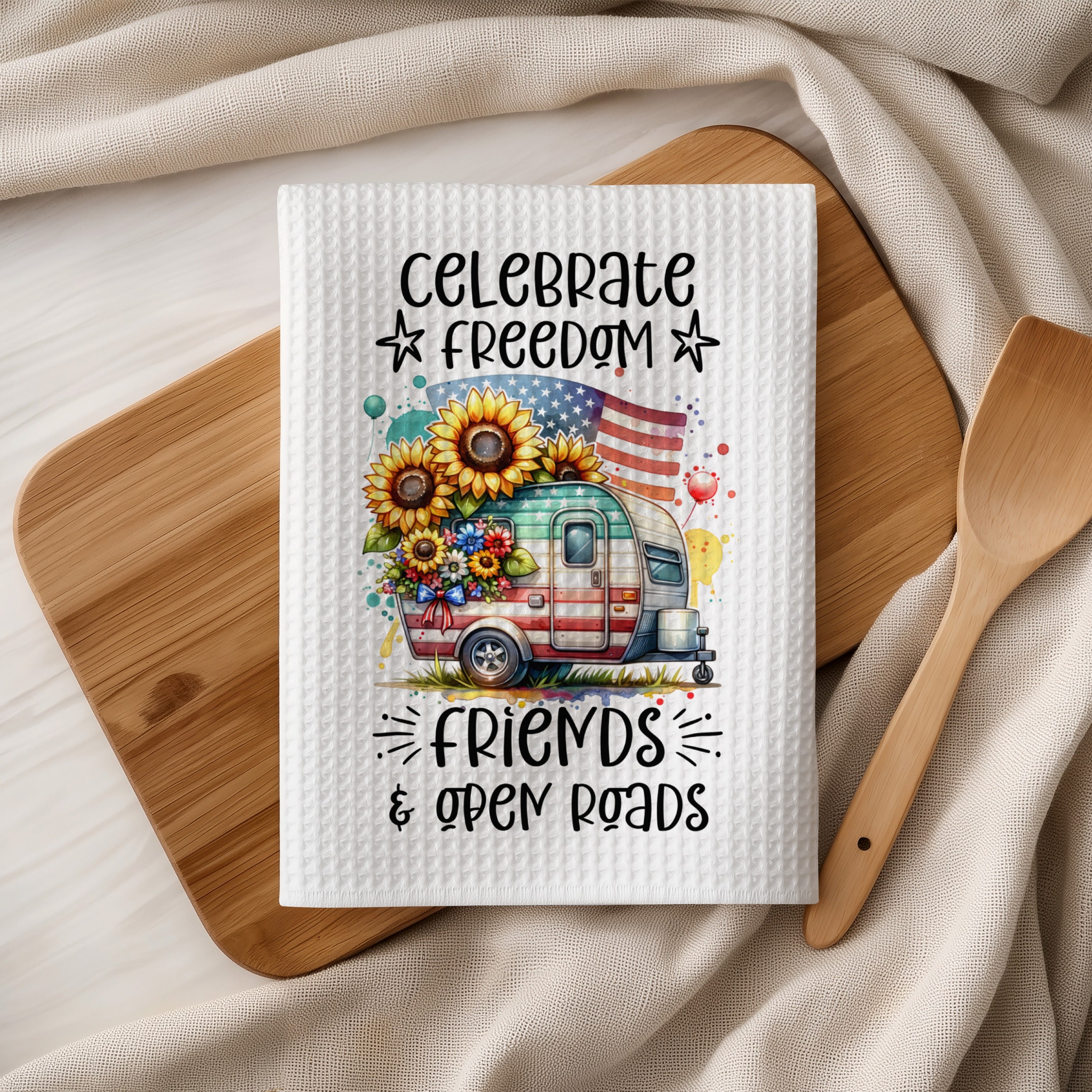 Camper with sunflowers and American flag, "Celebrate Freedom & Open Roads".