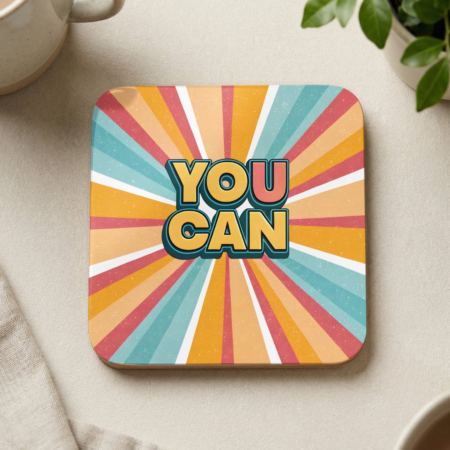 Square coaster with "YOU CAN" in colorful, retro sunburst design.