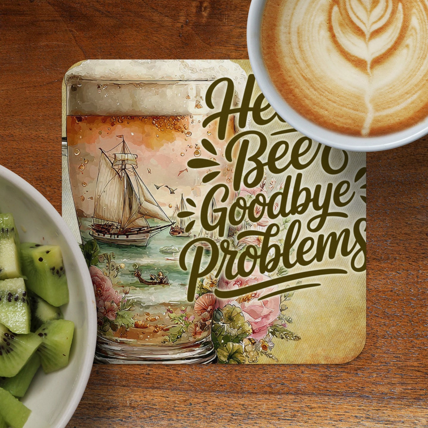 Coaster with "Hello Beer Goodbye Problems" text and seaside scene.