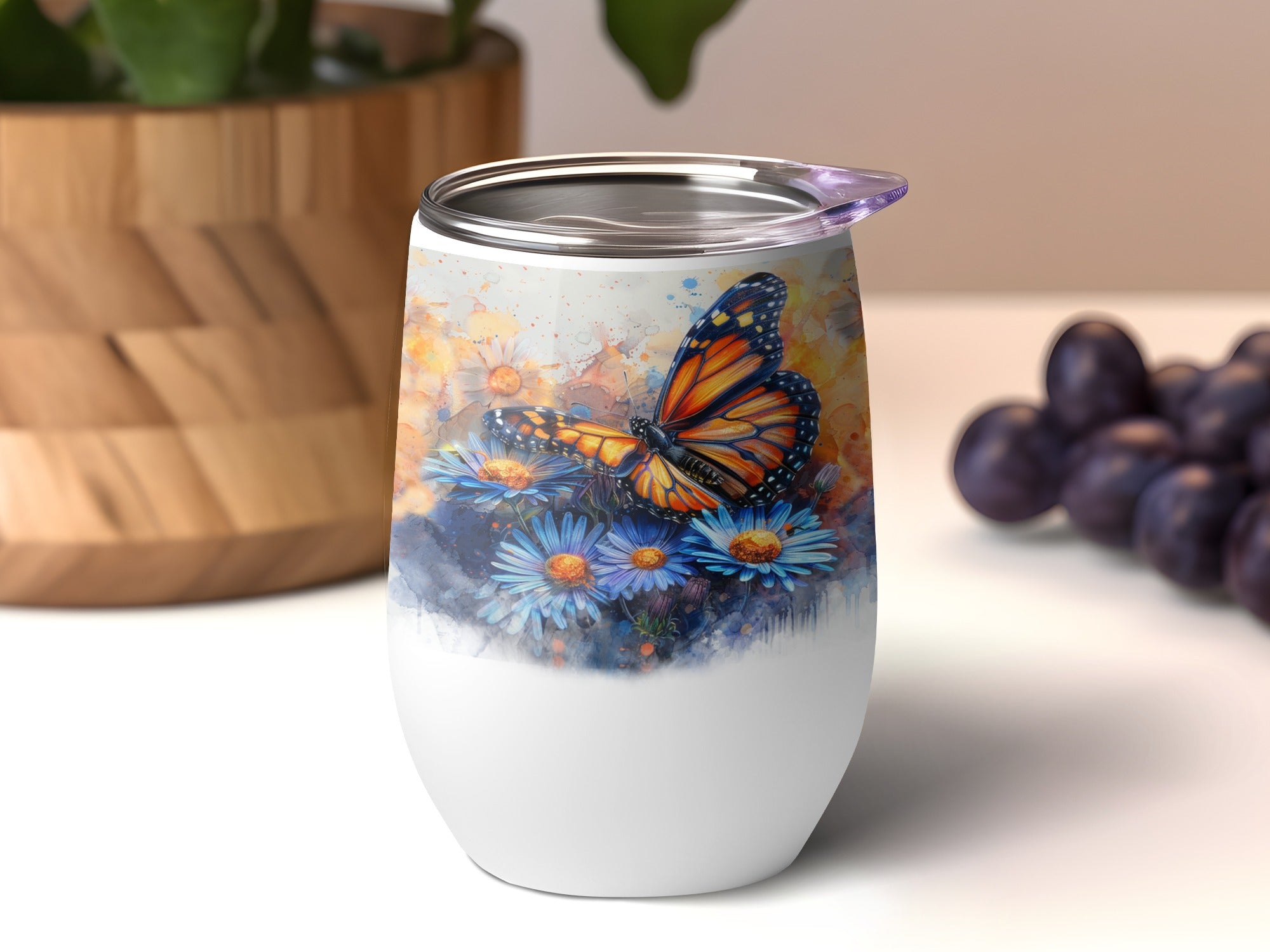 White tumbler with monarch butterfly and blue flowers, purple lid.