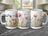 Three white mugs with a watercolor floral design wrapping around them.
