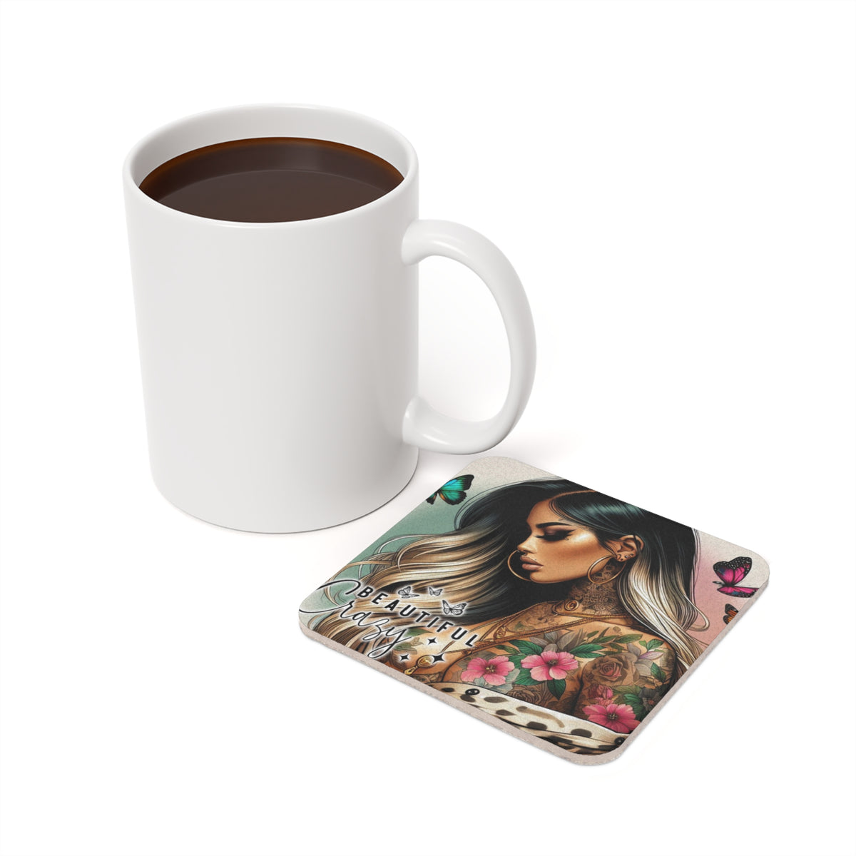 White mug of coffee next to square coaster with tattooed woman and butterflies.