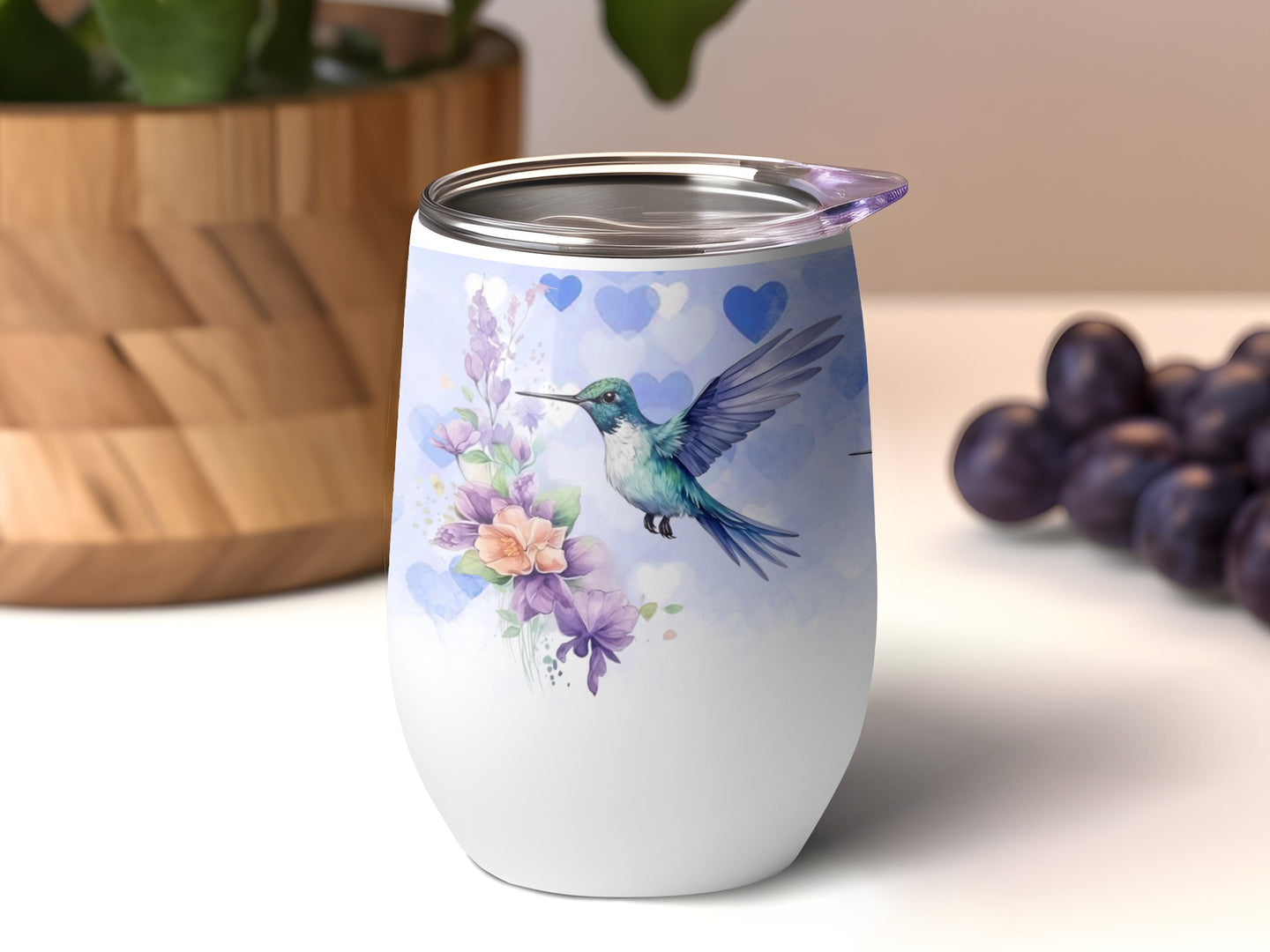 White tumbler with hummingbird and floral watercolor design, purple hearts.