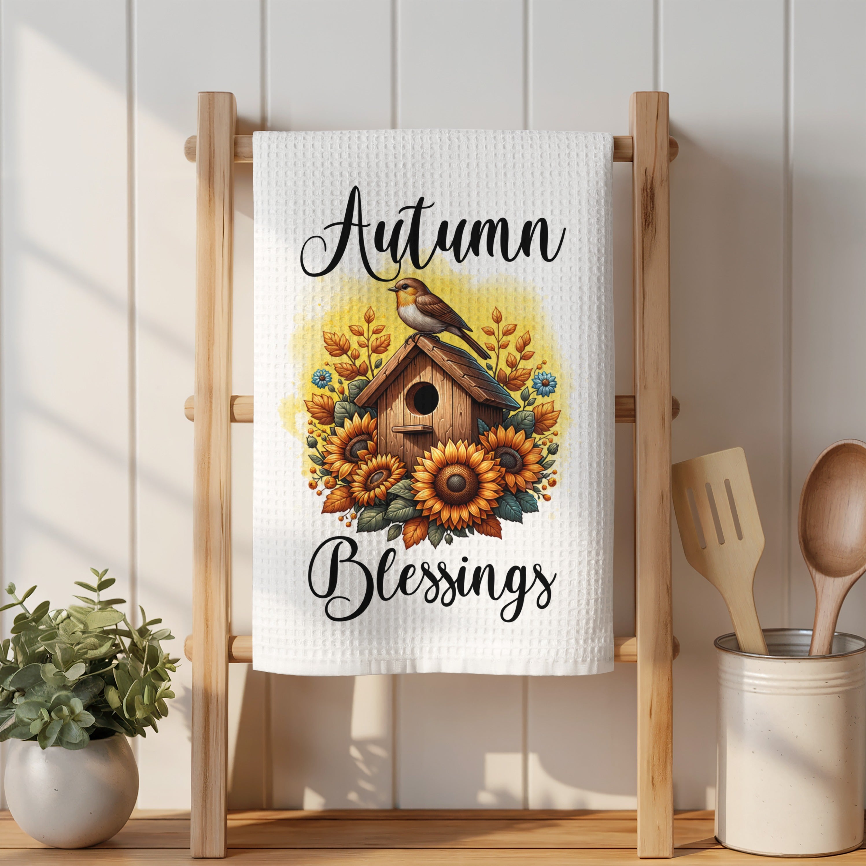 White towel with sunflowers, birdhouse, and "Autumn Blessings" text.