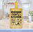 Mom's Kitchen sign on a wooden cutting board with "Love Served Daily" and meal times.