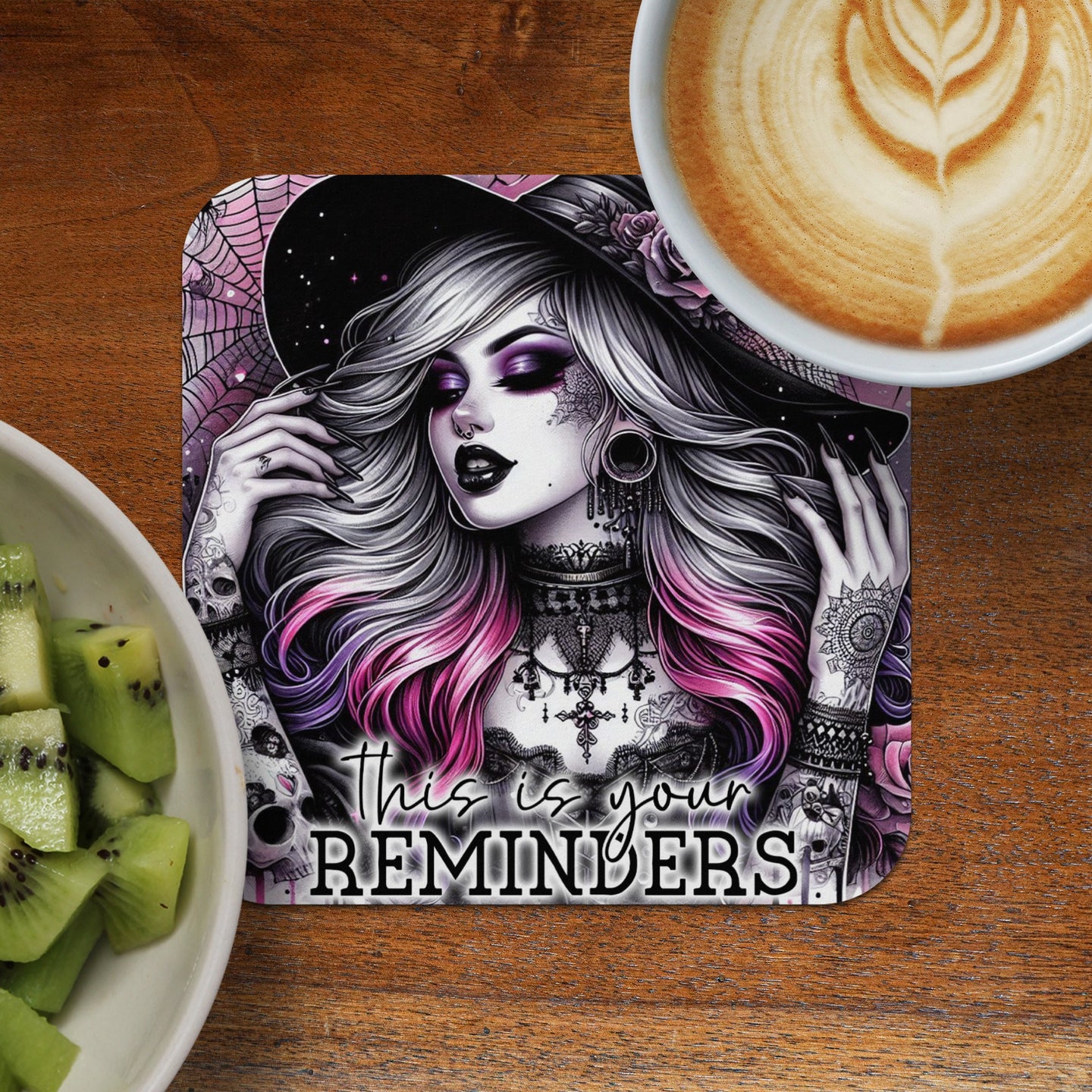 Gothic woman with pink hair and tattoos, text "This is your REMINDERS" on a coaster.