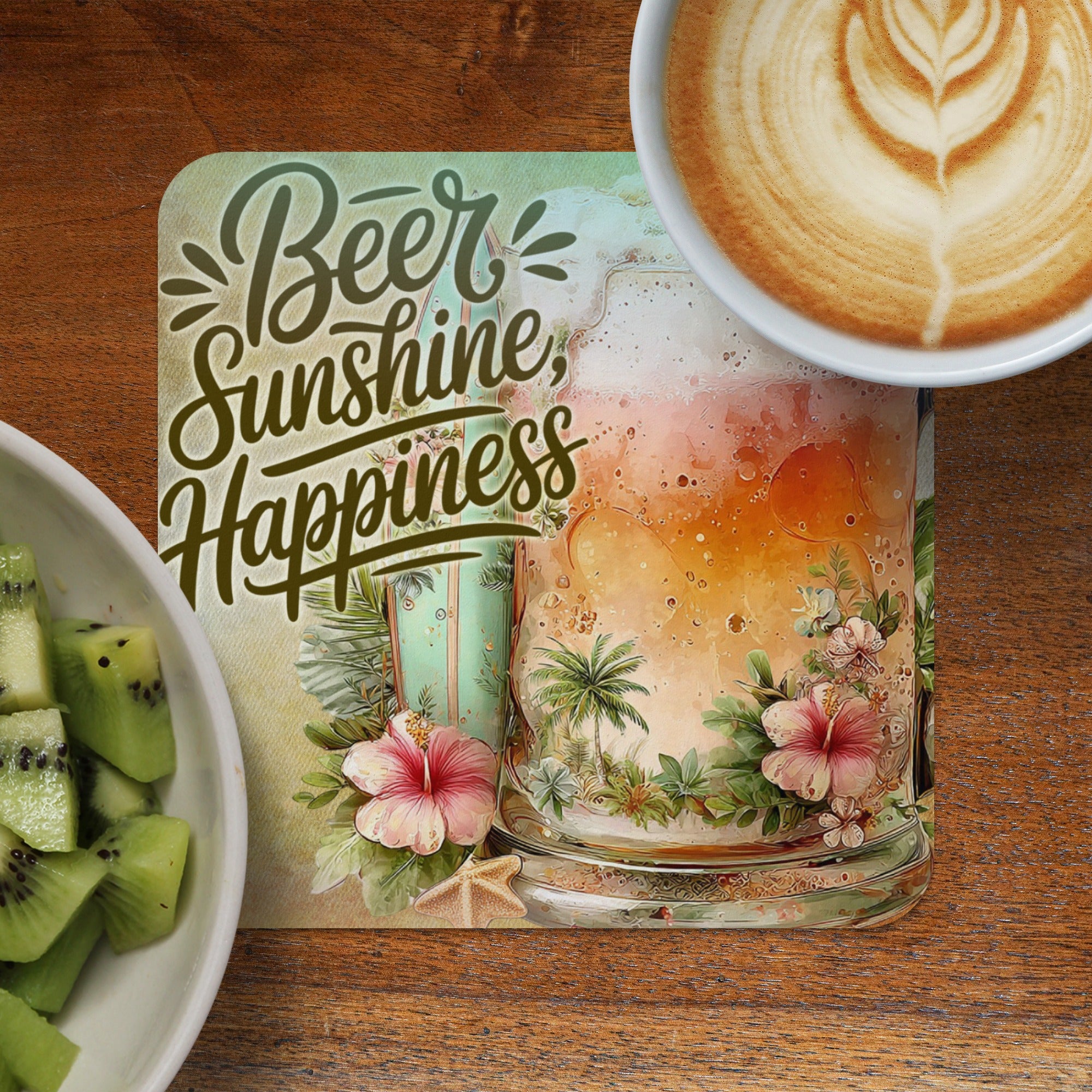 Coaster with "Beer Sunshine Happiness" text and tropical scene beside coffee and kiwi.