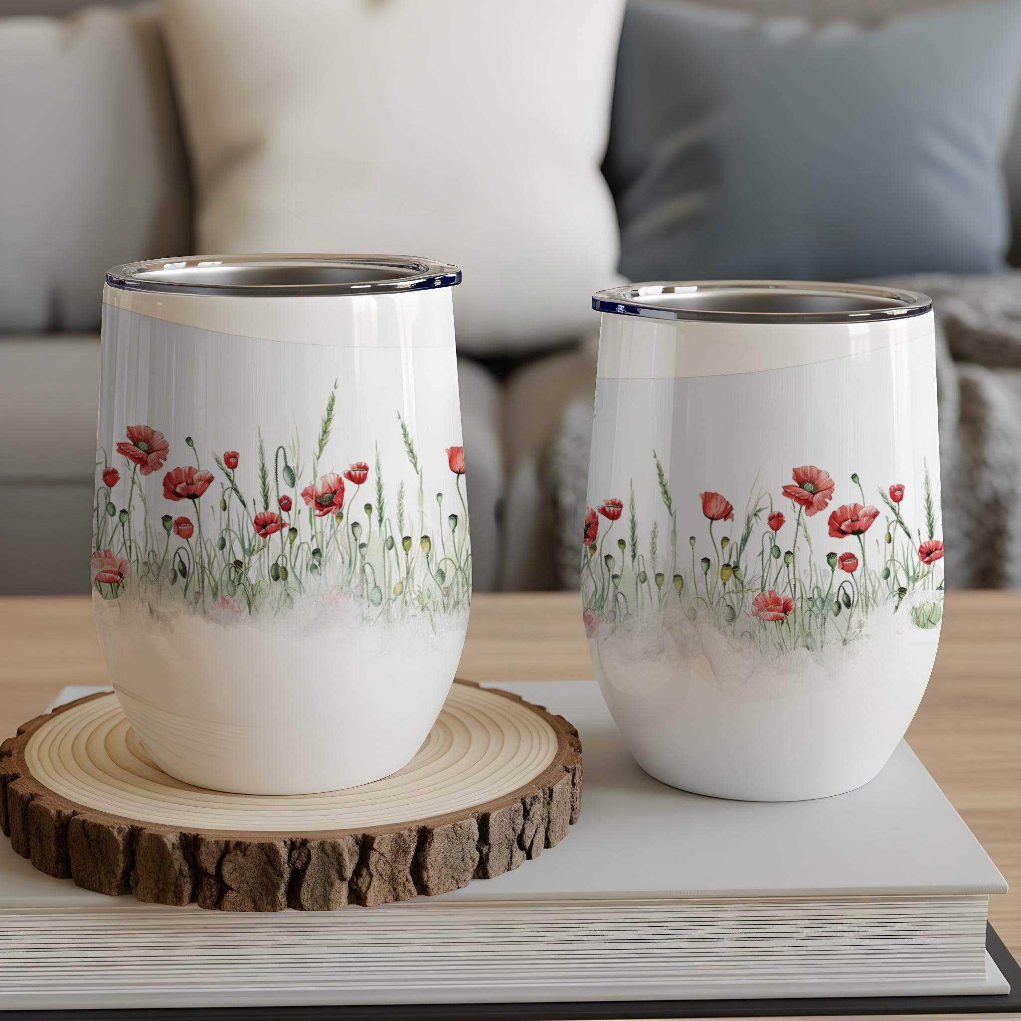 Two white tumblers with a red poppy and green grass floral design.